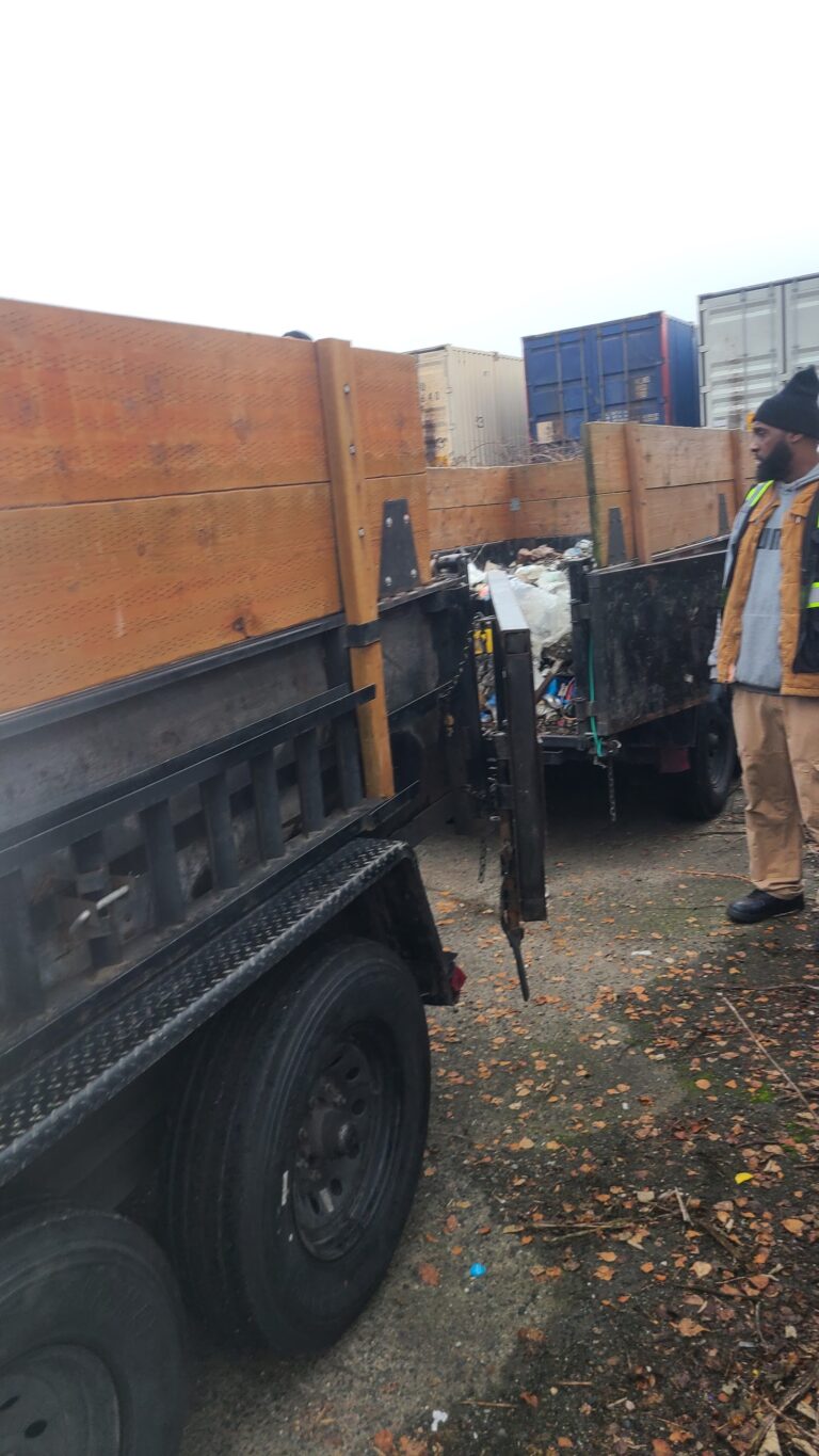 Crew loading debris into a dump trailer