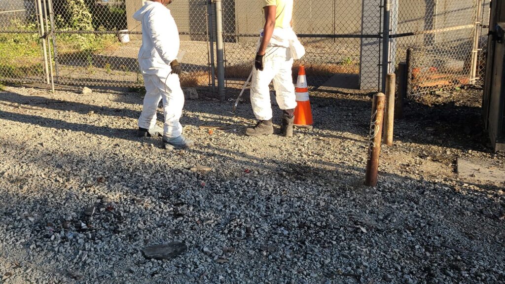 Fresh Family hazardous waste crew in Tyvek suits on a utility site