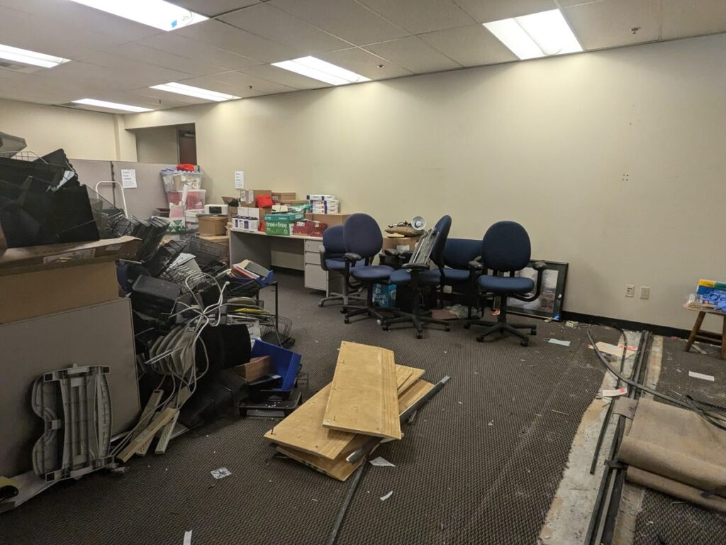 Office full of furniture and boxes before relocation