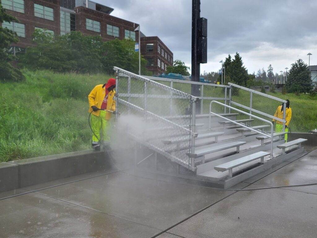 Fresh Family crew pressure washing bleachers at UW Bothell