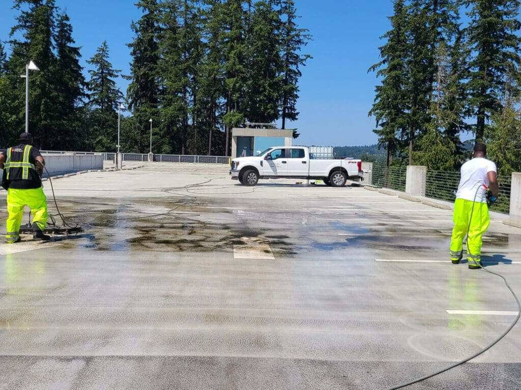 Fresh Family crew pressure washing the top deck of the UW Bothell parking garage