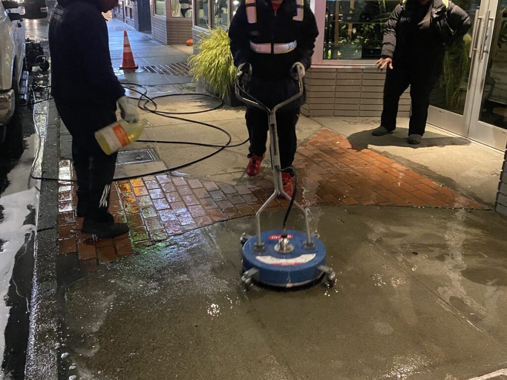 Night crew with surface cleaner washing downtown Renton sidewalks