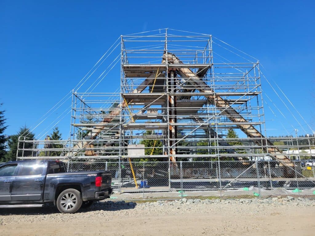 Scaffolding and abrasive blast containment built around the SR 167 Puyallup River Bridge steel truss