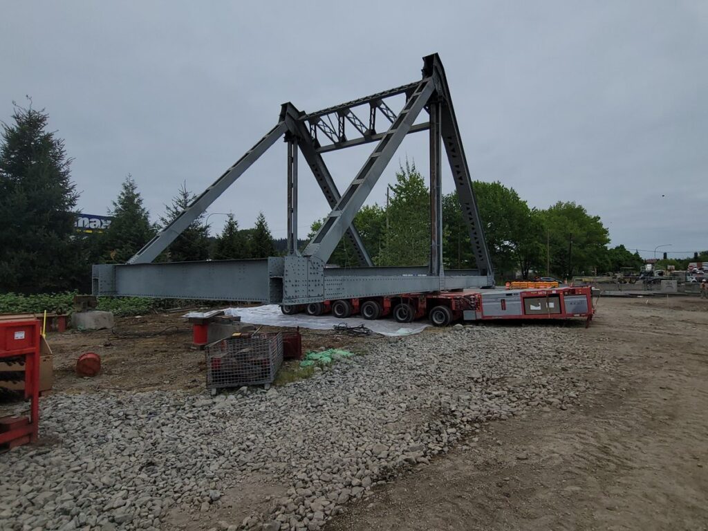 Puyallup River Bridge truss section loaded on transporters for removal