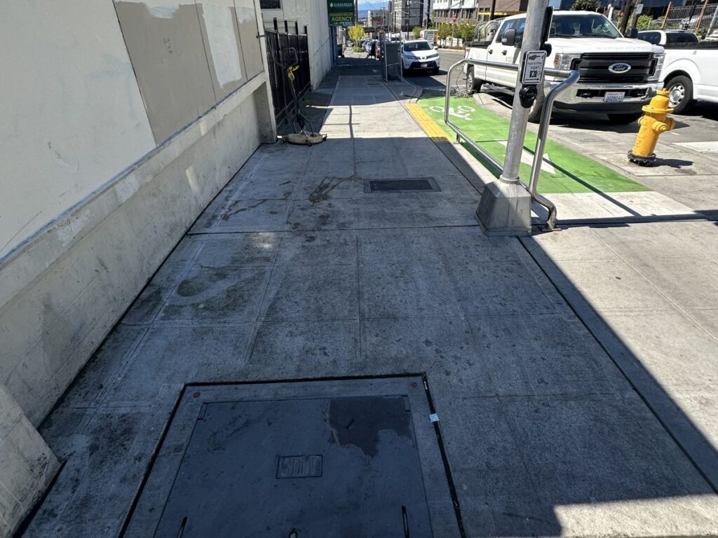 Pressure washed sidewalk along a Little Saigon business frontage