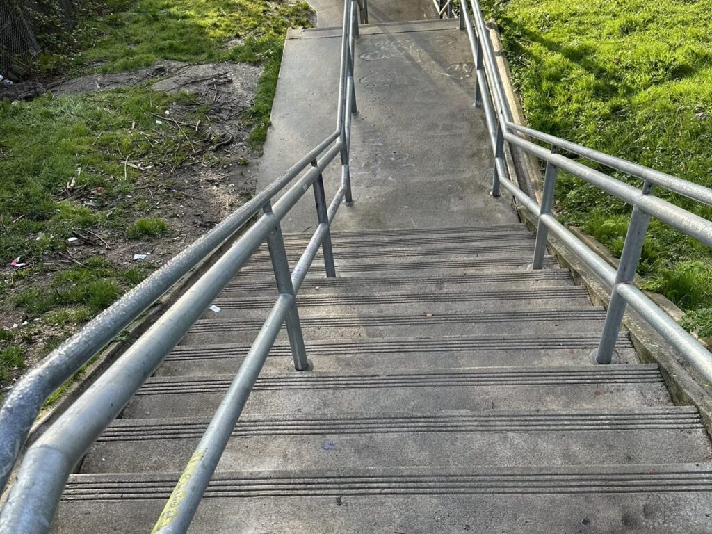 Public stairway and handrails pressure washed in Seattle Little Saigon