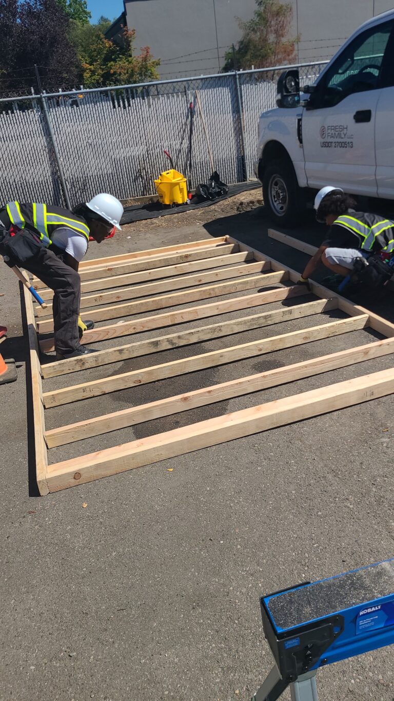 Building Futures trainees framing the tiny home floor system