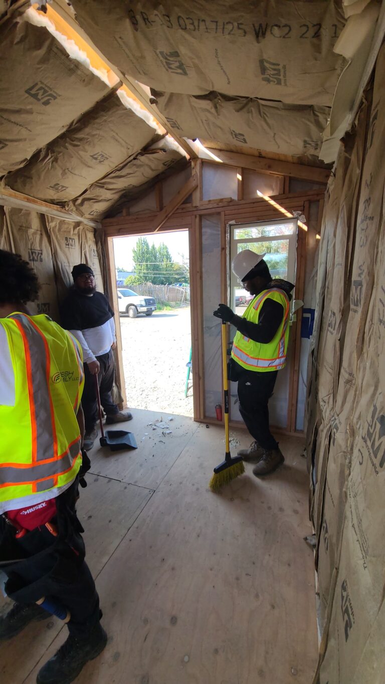 Trainees finishing the tiny home interior