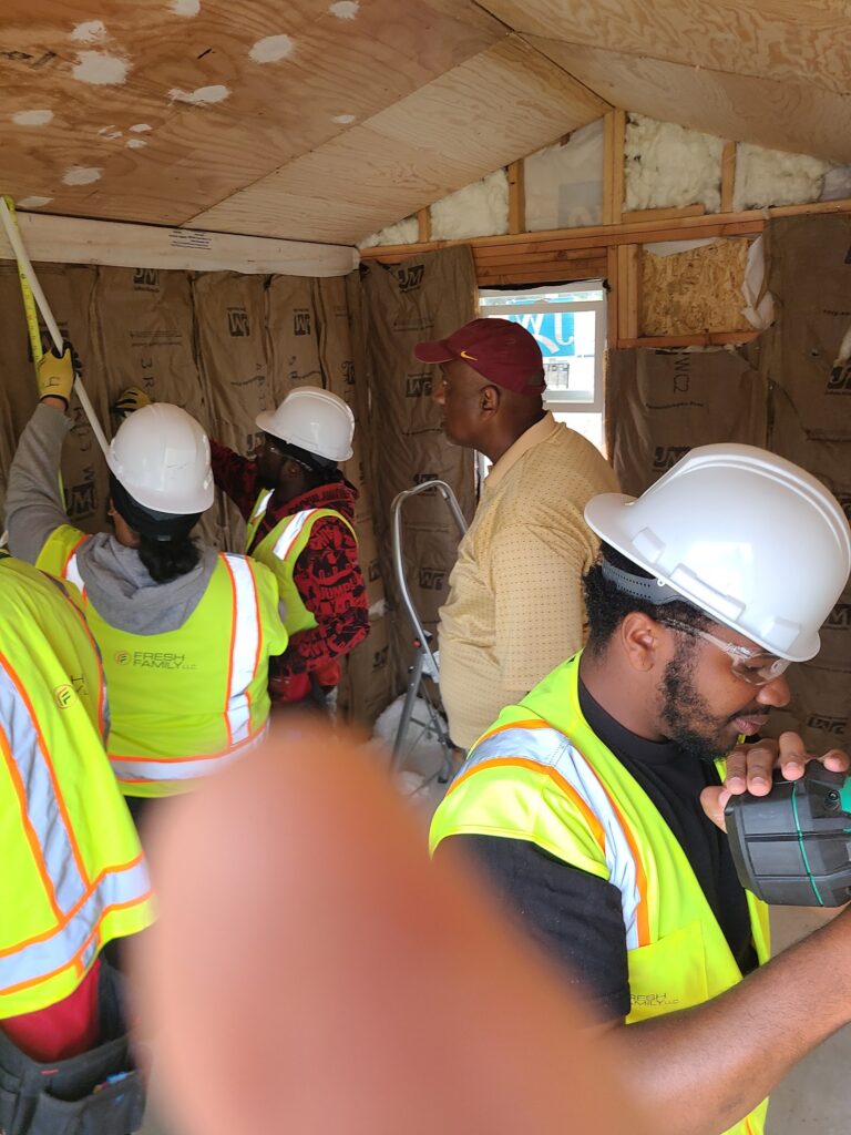Instructor and trainees inside the tiny home