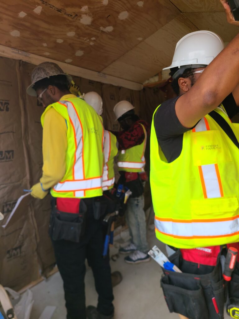 Trainees working inside the tiny home