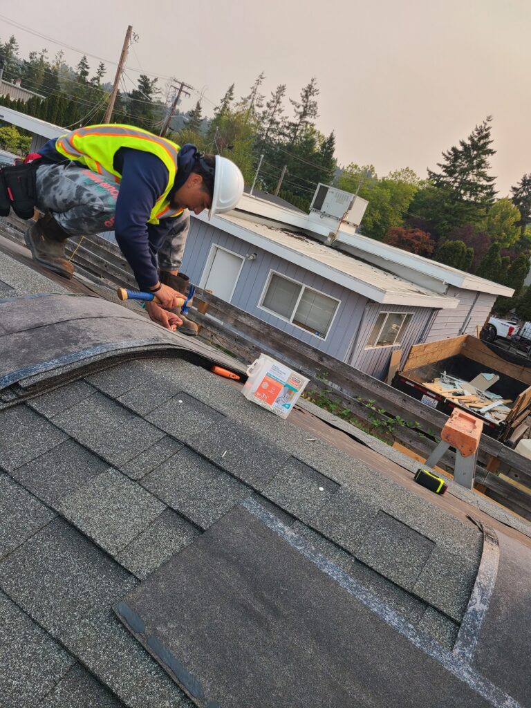 Trainee installing roofing on the tiny home